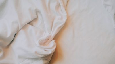 Crumpled white bed sheets in soft light