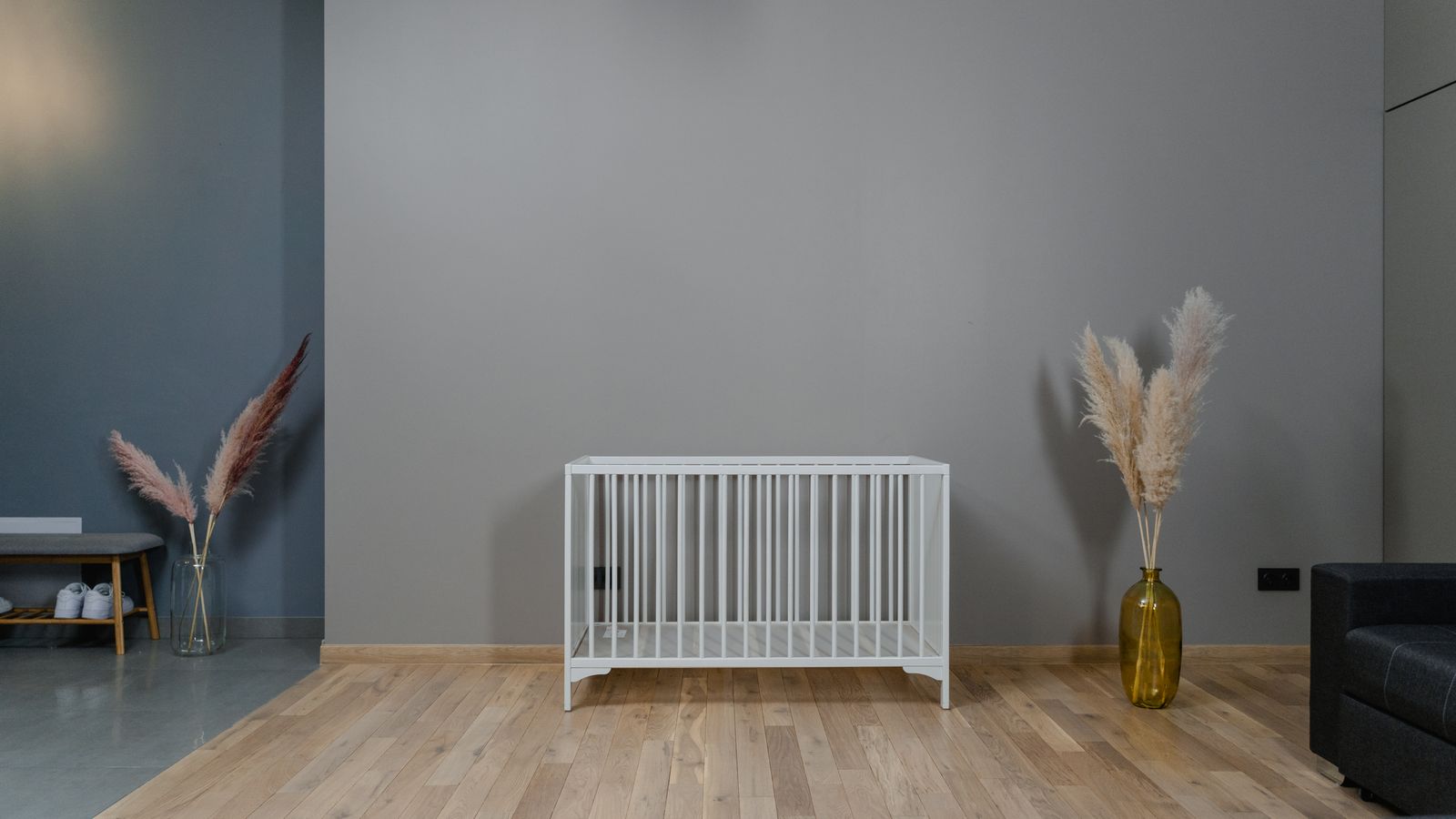 Empty white crib in a plain room