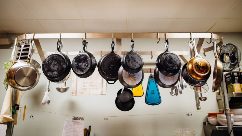 Assorted pans hanging from a pot rack