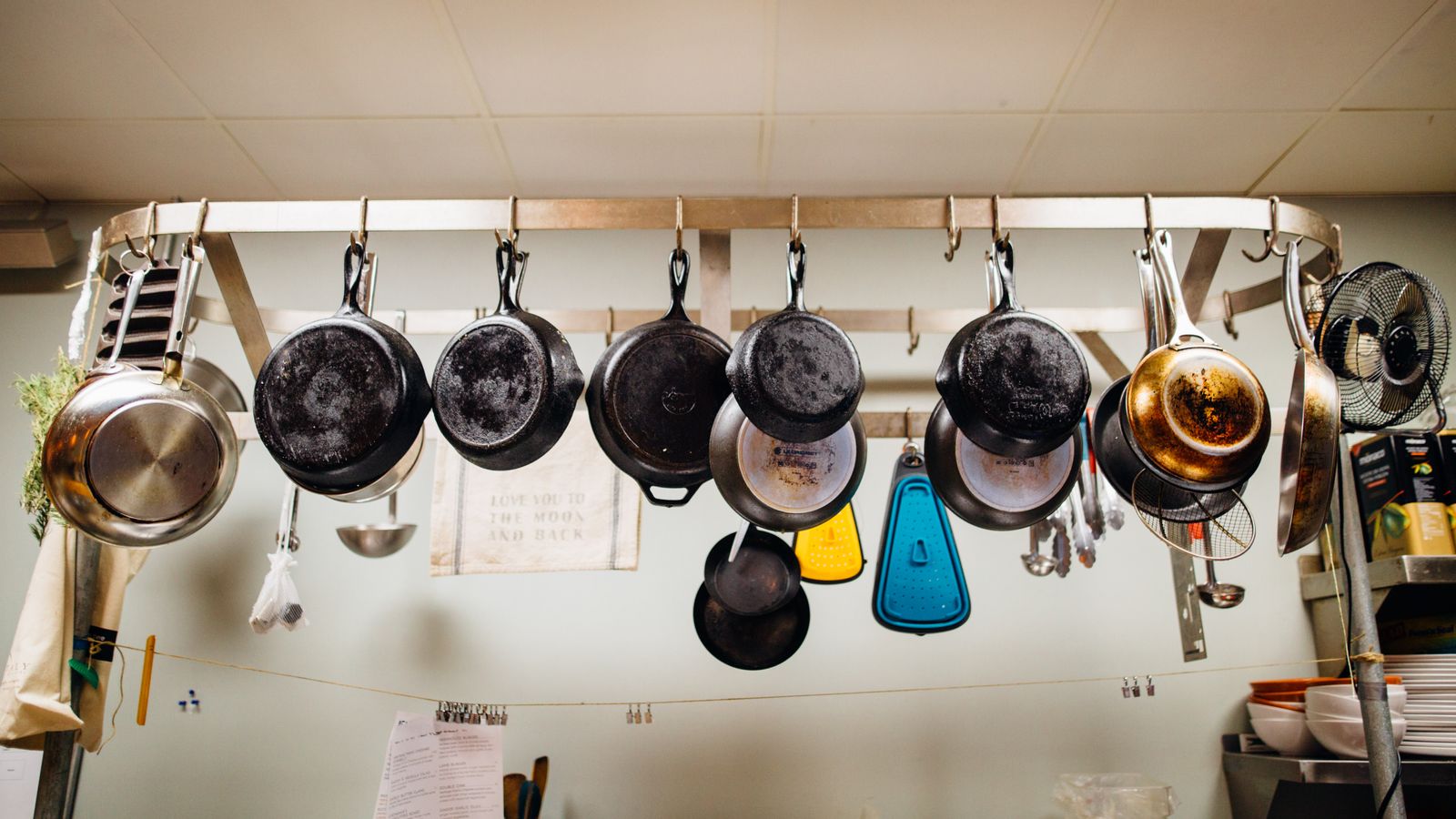 Assorted pans hanging from a pot rack