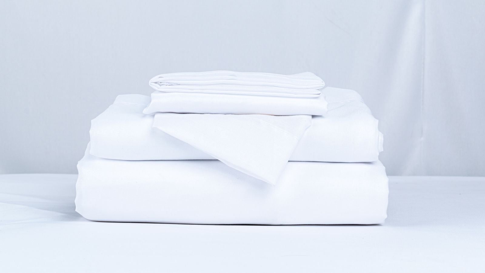 Stack of folded white bed linen