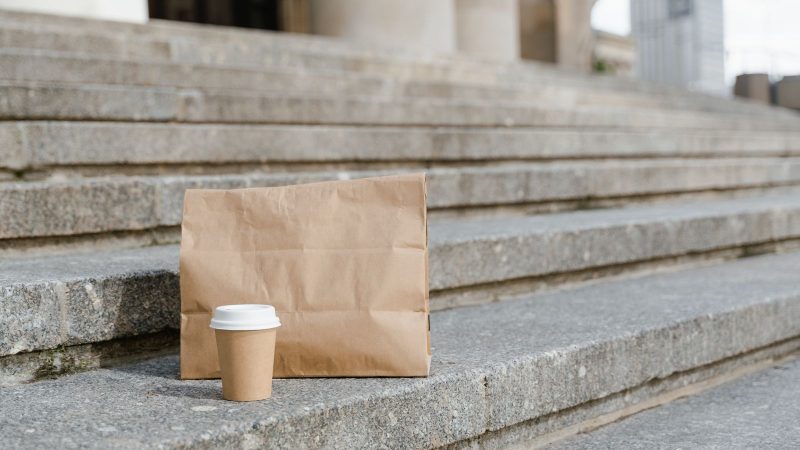 Paper takeaway bag left on concrete steps