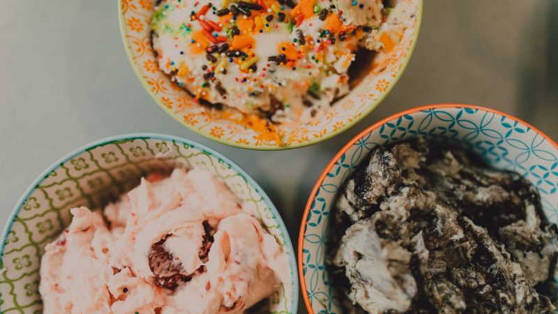 Three bowls of ice cream in different flavors seen from above