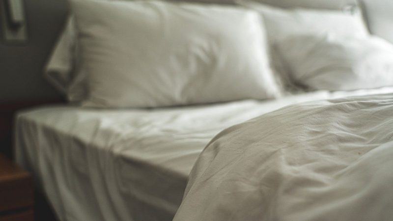 White bed with pillows and soft linen
