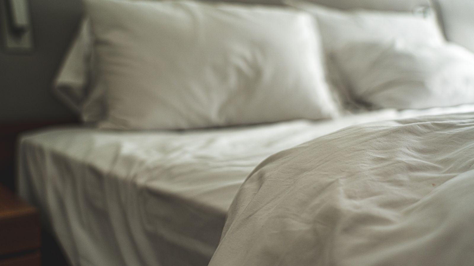 White bed with pillows and soft linen